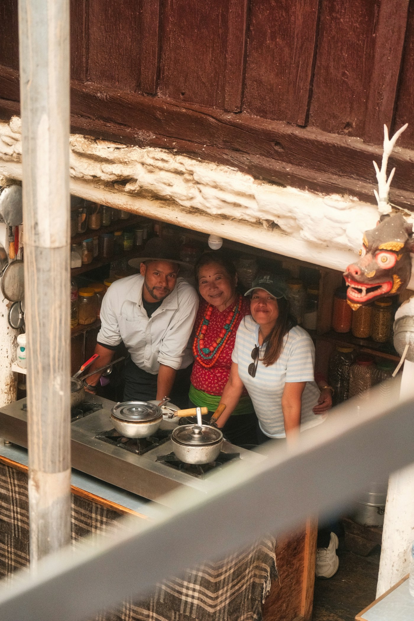 Family cooking together in a small kitchen
